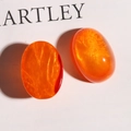 Macro shot of oval orange resin charms with sparkling sand effect for DIY jewelry making - Dark Orange