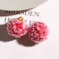 Detailed macro view of red and white teddy faux fur plush balls with gold metal rings - Red
