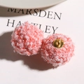 Macro detail of pink lamb wool pompom charms with metal loops for DIY jewelry - Pink
