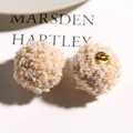 Close-up of curly faux teddy fur charms in cream and coffee tones for DIY jewelry crafts - Light Coffee