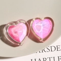 Detail shot of heart-shaped resin charms with shimmering pink facets and 3D textures - Pink