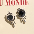 Detailed view of silver lava-style metal pendant with a centered black round gemstone - Silver Black