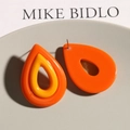 Detail of orange and yellow teardrop resin earrings with a hollow color-block design - Orange
