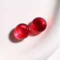 Macro shot of two transparent red spherical resin beads for DIY jewelry making accessories - 1 Piece / Red