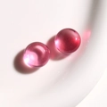 Macro shot of two round translucent pink resin beads with a glossy finish for jewelry DIY - 1 Piece / Pink