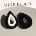 Detailed view of bicolor resin teardrop earrings with a hollow black and white design - Black and White