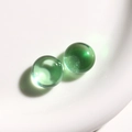 Macro shot of transparent emerald green resin cabochons for DIY jewelry and crafts - 1 Piece / Green