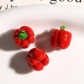 Detailed close-up of resin mini bell pepper charms with gold rings for DIY jewelry - Red