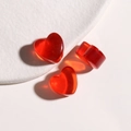 Detailed view of red heart resin charms with gold glitter and glossy finish for DIY - Red