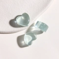 Macro shot of translucent light blue resin heart pendants and a matching chunky ring - Light Blue