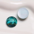 Macro shot of vintage round resin cabochons with blue and teal marble water wave patterns - 1 Piece / Green