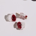 Detailed macro view of dual-color resin flower charms with crystal center and gold posts - Dark Red