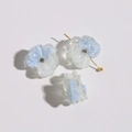 Detailed macro view of clear blue gradient petal resin earrings with rhinestone accents - Light Blue