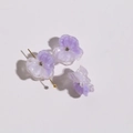 Macro shot of purple gradient resin flower charms with crystal centers and gold pins - Purple