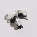 Detailed macro of black and white flower charms with resin petals and inset rhinestones - Black