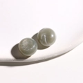 Detailed view of 15mm sage green resin beads with subtle glitter on a white stand - 15mm (1 Piece/Pack) / Gray