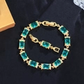 Elegante bracciale in oro con pietre verde smeraldo e pavé di zirconi bianchi su velluto scuro - Oro Blu Chiaro