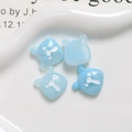Macro shot of 4 light blue resin bear charms for DIY jewelry and phone case making - Marbled Blue