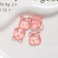 Close-up of four translucent pink resin cartoon bear charms for DIY jewelry making - Transparent Pink
