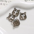 Detail shot of four translucent gummy bear resin charms on a white ceramic tray - Transparent Gray