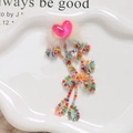 Close-up of colorful tassel beads with sequins and heart faux fur for DIY crafts - Rose Red Heart Style / Rose Red