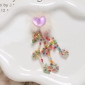 Close-up of a purple heart and white fur puff with colorful beaded sequin tassels - Light Purple Heart Style / Light Purple