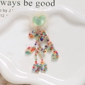 Close-up of heart-shaped glitter charm with faux fur and colorful beaded tassels - Light Green Heart Style / Light Green