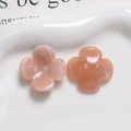 Close-up of resin four-petal flower charms with marble texture for DIY accessories - Deep Pink