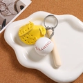 Macro view of mini baseball keychain with leather glove and wooden bat set - Yellow