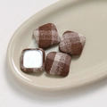 Macro detail of square brown checkered fabric buttons with flat metal base for DIY hair accessories - Square Coffee