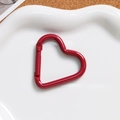Macro view of a red heart-shaped carabiner with glossy finish for DIY keychain crafts - Dark Red