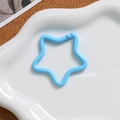 Detail of light blue star-shaped alloy spring clasp on white plate for DIY crafts - Blue