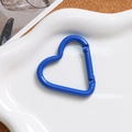 Close-up of a heart-shaped blue carabiner with spring gate on a white decorative tray - Dark Blue