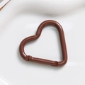 Macro view of a brown heart-shaped alloy spring clasp with smooth glossy finish - Brown Coffee