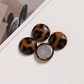 Close-up of leopard print fabric buttons with silver metal back for DIY crafts - Coffee Matte