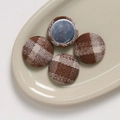DIY brown plaid fabric buttons with silver metal base on a ceramic tray - Round Coffee