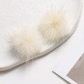 Macro detail of fluffy 3.5cm ivory faux mink fur pom-poms for DIY jewelry and accessories - Off White