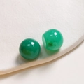 Macro shot of 20mm green translucent ink-wash resin beads for DIY jewelry making - Green