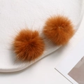 Detail of soft 3.5cm bright orange mink fur pom poms for DIY jewelry on ceramic plate - Dark Coffee