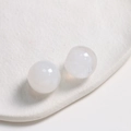 Macro shot of 20mm round white ink-style resin cabochons with smooth matte finish for DIY - White