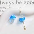 Macro view of blue polka dot glass mushroom beads for DIY jewelry making - Light Blue with White Polka Dots