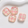 Close-up of pink checkered resin squares for DIY phone case and jewelry accessories - Pink