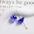 Detailed macro view of blue lampwork glass mushroom beads with white polka dots for jewelry - Dark Blue with White Polka Dots