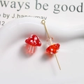 Macro view of red and white polka dot mushroom glass beads with golden DIY pin accessory - Red with White Polka Dots