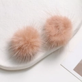 Close-up of soft pinkish-orange mink fur balls on a white tray for DIY craft jewelry - Lotus Pink