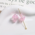 Close-up of pink translucent glass mushroom beads with spiral patterns for DIY jewelry - White Plaid Pink