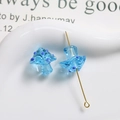 Close-up of translucent light blue glass mushroom beads with purple dots for DIY jewelry - Transparent Blue with Blue Polka Dots