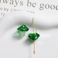 Macro shot of green spotted mushroom glass beads with gold pins for DIY jewelry making - Transparent Green with White Polka Dots