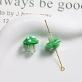 Macro shot of green polka dot glass mushroom beads with central drill holes for DIY jewelry - Gradient Green with White Polka Dots