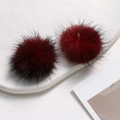 Macro shot of fluffy dark burgundy mink fur balls for DIY jewelry and hair accessories - Black Red